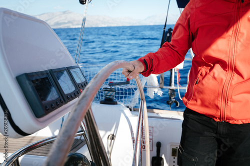 Attractive strong woman sailing with her boat photo