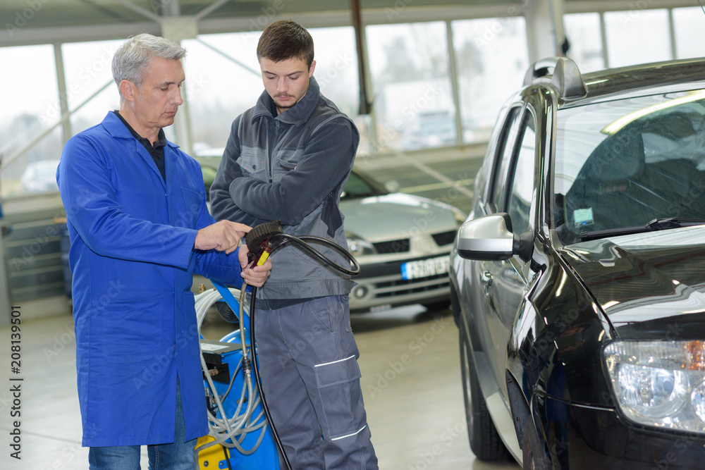 teenager in professional training with garage owner