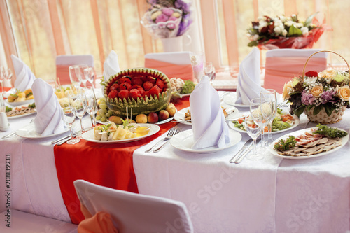 wedding tables in restairant, nobody at begining, red interior photo