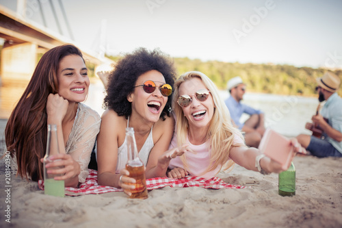 Portrait of three young female friends on the beach © ivanko80