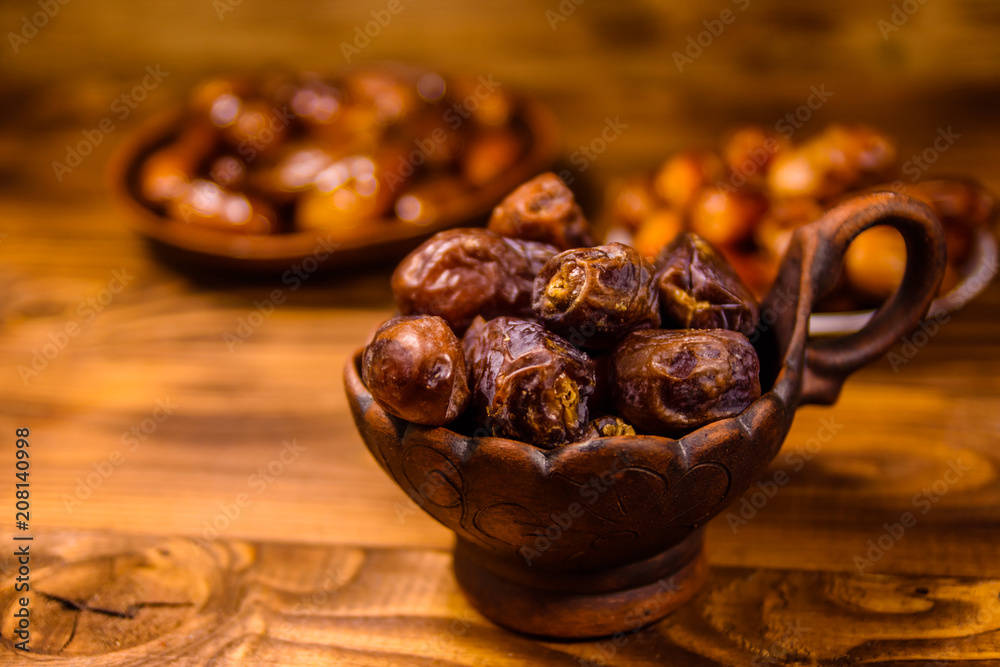 Date fruits on the rustic wooden table Date fruits on the rustic wooden table