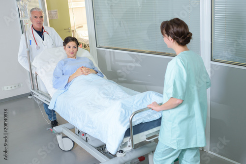 Obraz na plátně female patient on stretcher or gurney being pushed in hospital