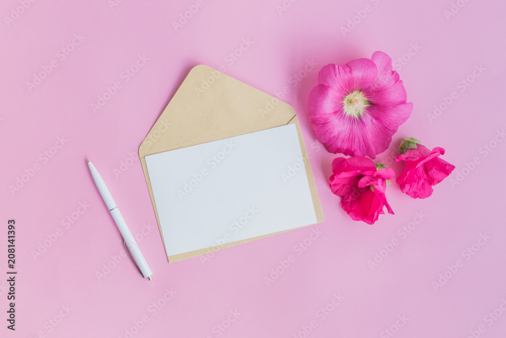 Mockup white greeting card and envelope with pink flowers Mockup white greeting card and envelope with pink flowers