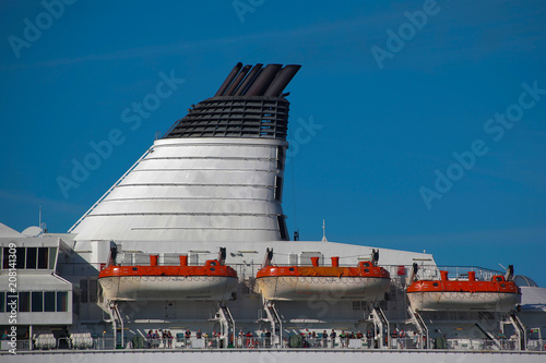 A large chimney and lifeboats