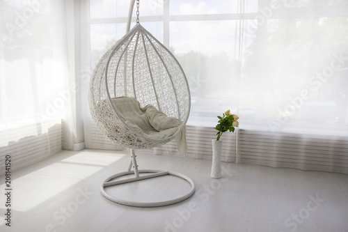White interior. White hanging chair. Cocoon chair photo