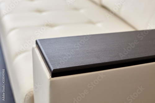 A studio shot of a detail of white leather sofa in a living room.