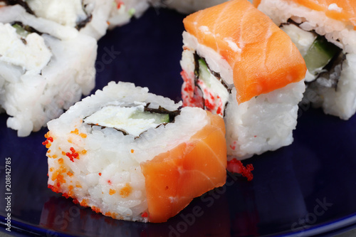 Sushi is very close-up on a dark blue background. Sushi with fish. A beautiful photo of food. photo