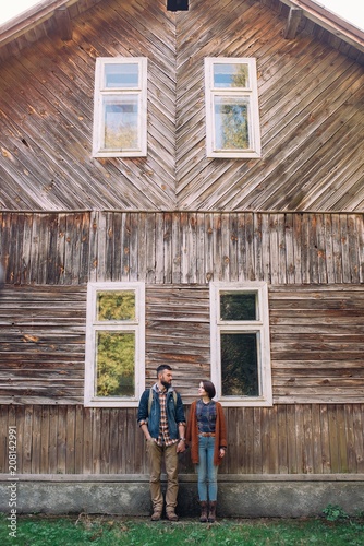 couple near old wooden house