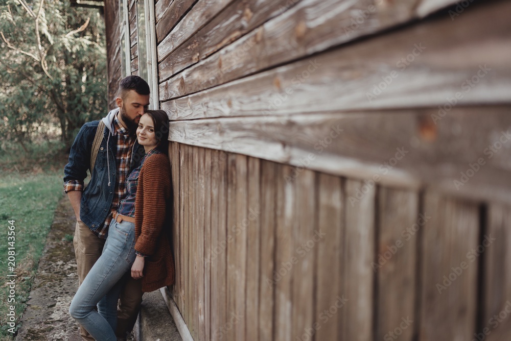 couple near old wooden house couple near old wooden house