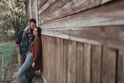 couple near old wooden house
