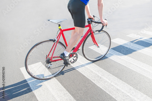 Cyclist rides a zebra on a red road bike. Riding a city on a bike. Sports concept.