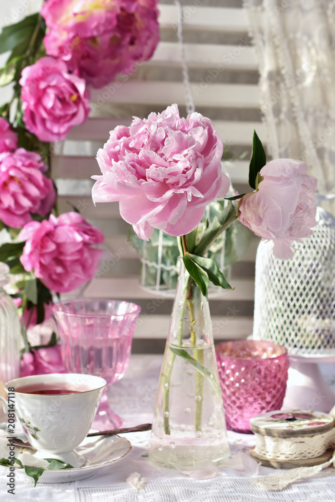 Obraz premium fruit tea in beautiful porcelain cup and peony flowers