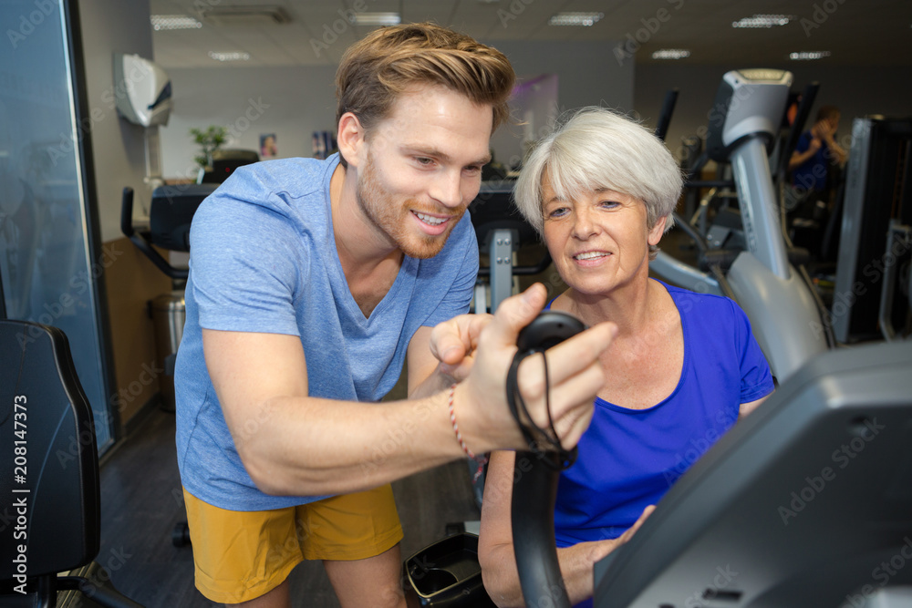 senior woman working out with personal trainer senior woman working out with personal trainer