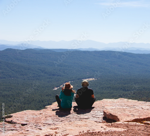 traveler young couple sitting and watching the forest scenery