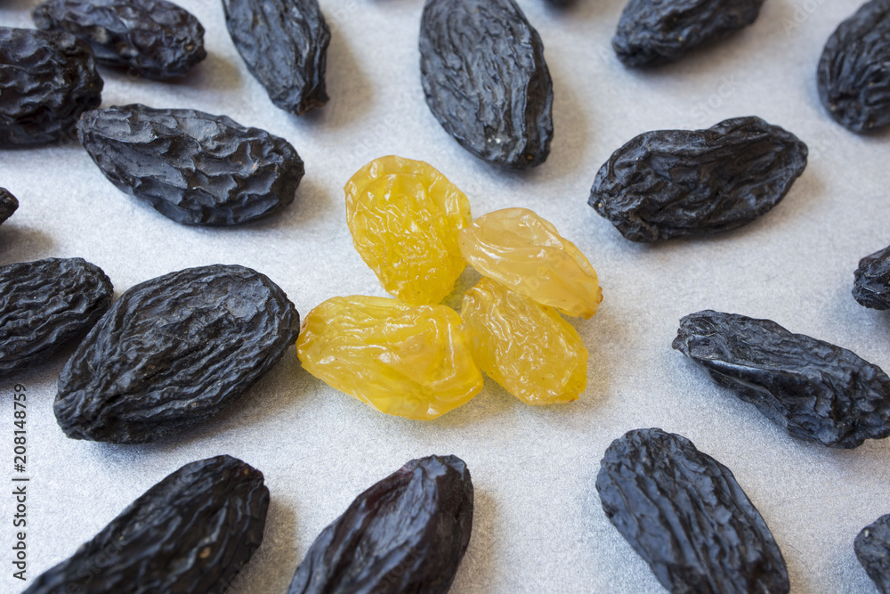 yellow raisins inside blue on grey background. vegetarian food yellow raisins inside blue on grey background. vegetarian food