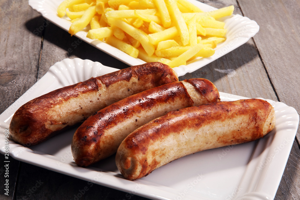 Grilled sausage served with french fries or fried potatoes with sausage