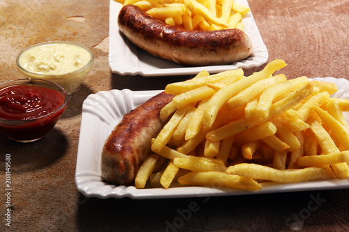 Grilled sausage served with french fries or fried potatoes with sausage