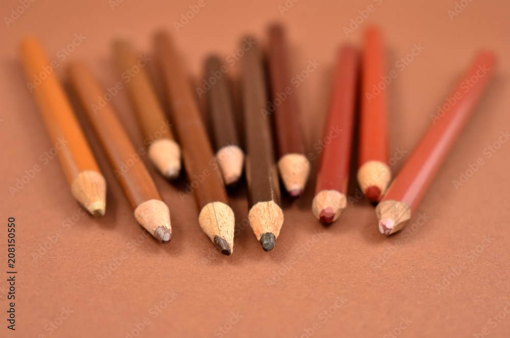 Brown crayons stock images. Set of brown crayons on a brown background. Art supplies images Brown crayons stock images. Set of brown crayons on a brown background. Art supplies images