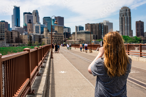 Woman taking picture of city skyline photo