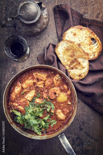 Traditional Creole cajun court bouillon with fish and seafood gumbo chowder stew as top view in a pot photo