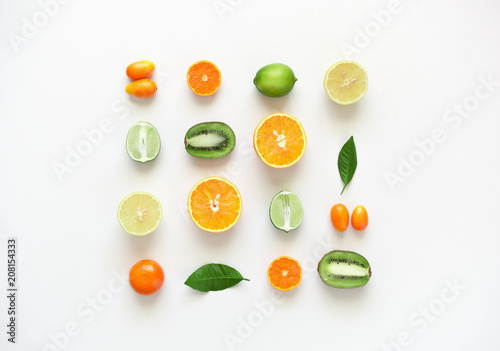 Fruit colorful background. Fresh fruits on white table background. Orange, tangerine, kiwi, lime, lemon. Flat lay, top view, copy space 