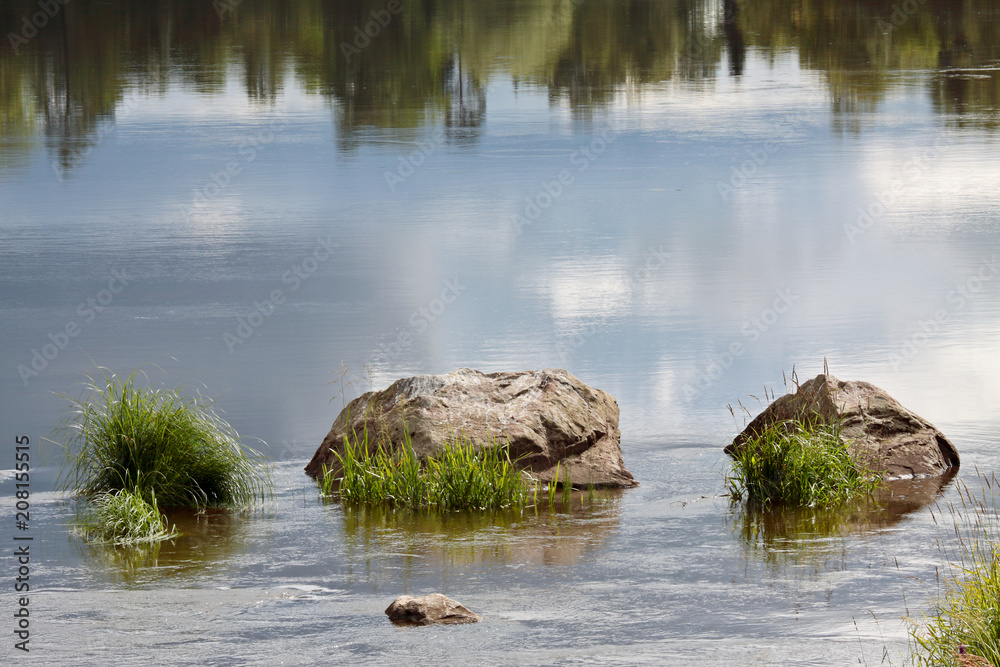 Three big stones in a flowing river Three big stones in a flowing river