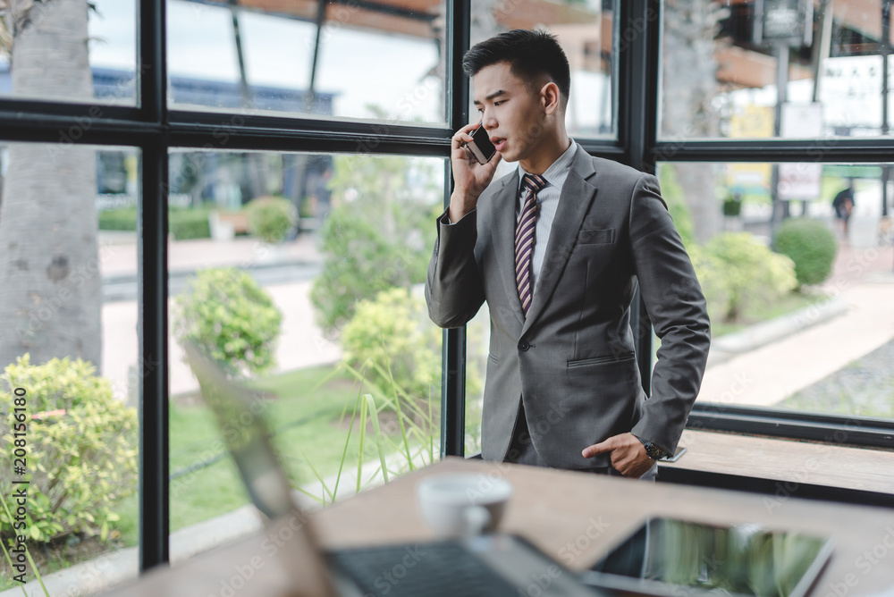 businessman talking on mobile phone in office businessman talking on mobile phone in office