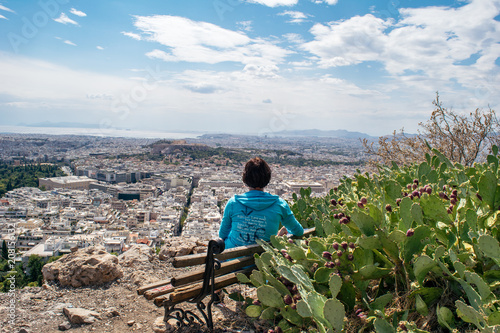 View of Athens and Acropolis (woman looking towards) from Lycabettus Hill (Mount Lycabettus), Athens Greece