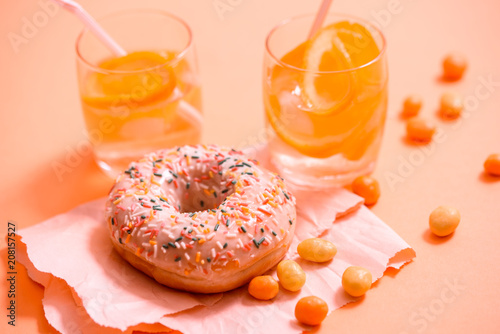 Sprinkled Pink Donut. Frosted sprinkled donut on pink background. photo