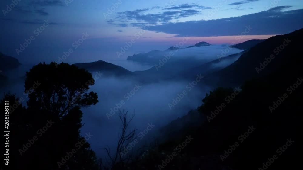 custom made wallpaper toronto digitalCoastline of Corsica with remote beach and covered in fog after sunset in blue hour