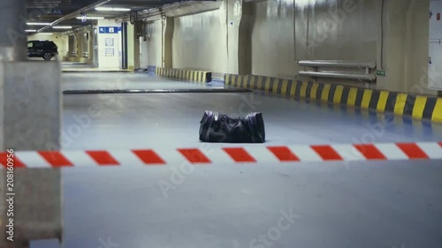 Wallpaper Mural Forgotten suspicious bag for tape caution underground parking lot Torontodigital.ca