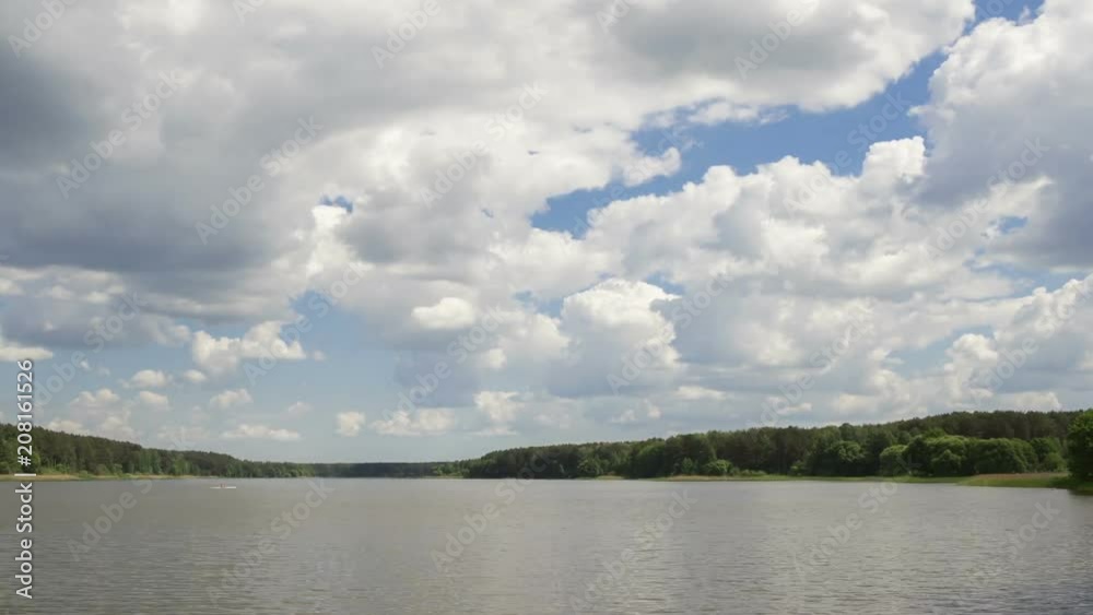 Cumulus cloud over the lake, time-lapse. The movement of clouds over a summer lake.
Cumulus cloud over the lake, time-lapse. The movement of clouds over a summer lake.