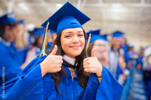 Thumbs up graduate at graduation ceremony photo