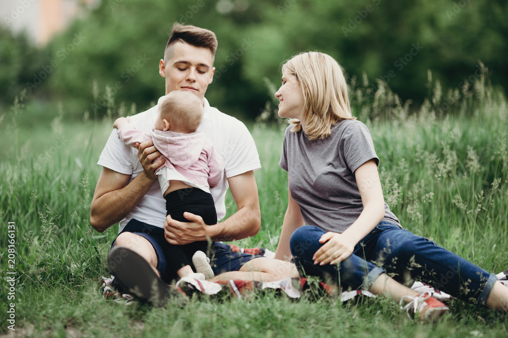 Happy family playing with baby daughter in nature Happy family playing with baby daughter in nature