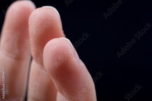 Three  fingers of a human hand partly seen in view photo