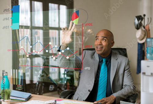 Handsome Business Man Using Futuristic Financial Graph