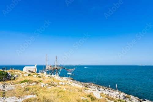 Trabucco of Molinella near Vieste, Apulia, Italy. A trabucco is a fishing machine common in Southern Italy's Adriatic coast photo