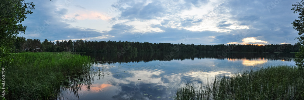 Panorama of sunset on the lake in twilight.