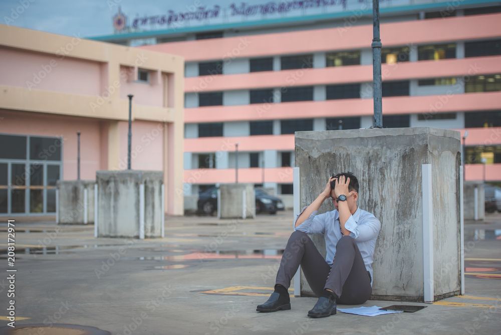 young caucasian businessman tired from work sitting at stairs, unemployment. young caucasian businessman tired from work sitting at stairs, unemployment.