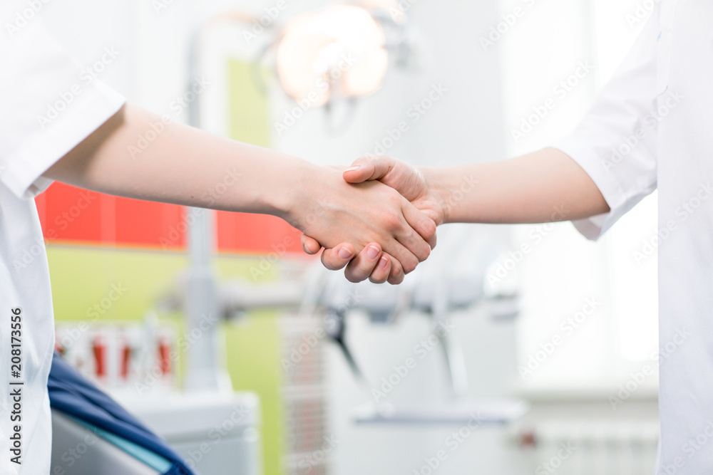 Fototapeta premium Handshake of Two Doctors in the Clinic