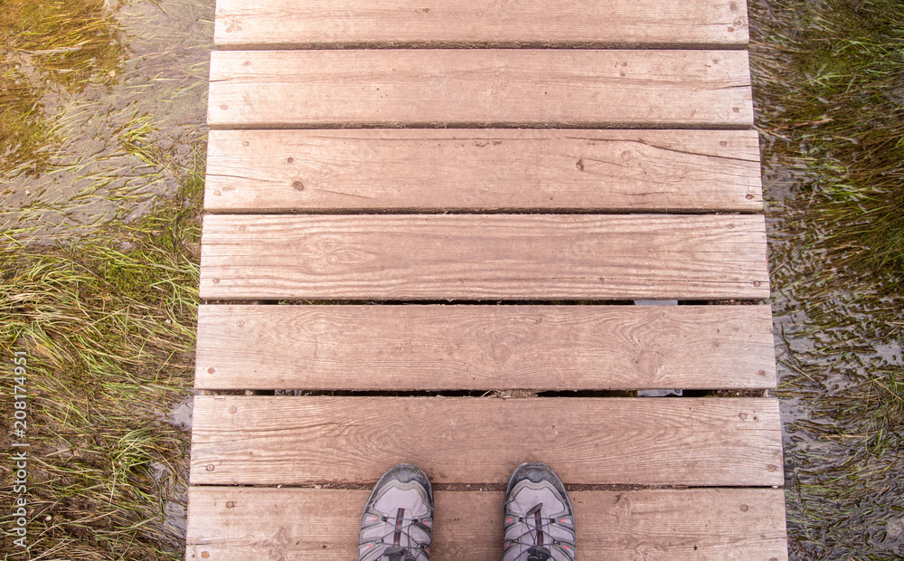 Fototapeta premium feet on wooden bridge