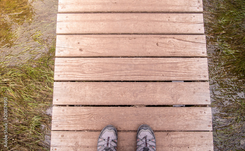 feet on wooden bridge