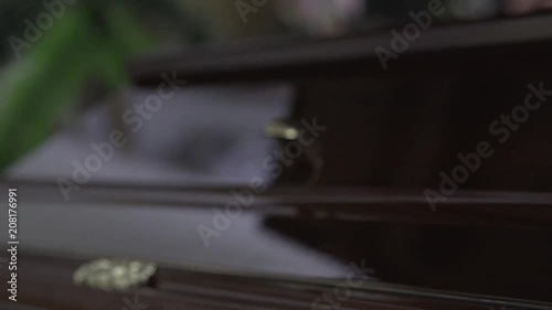 Funeral and mourning concept. Close up handheld shot of details of brown wooden coffin in church. photo