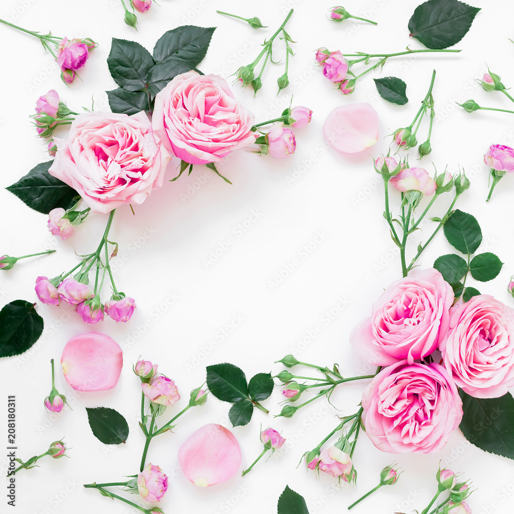Floral frame composition with roses flowers, leaves and buds on white background. Flat lay, top view. Frame background