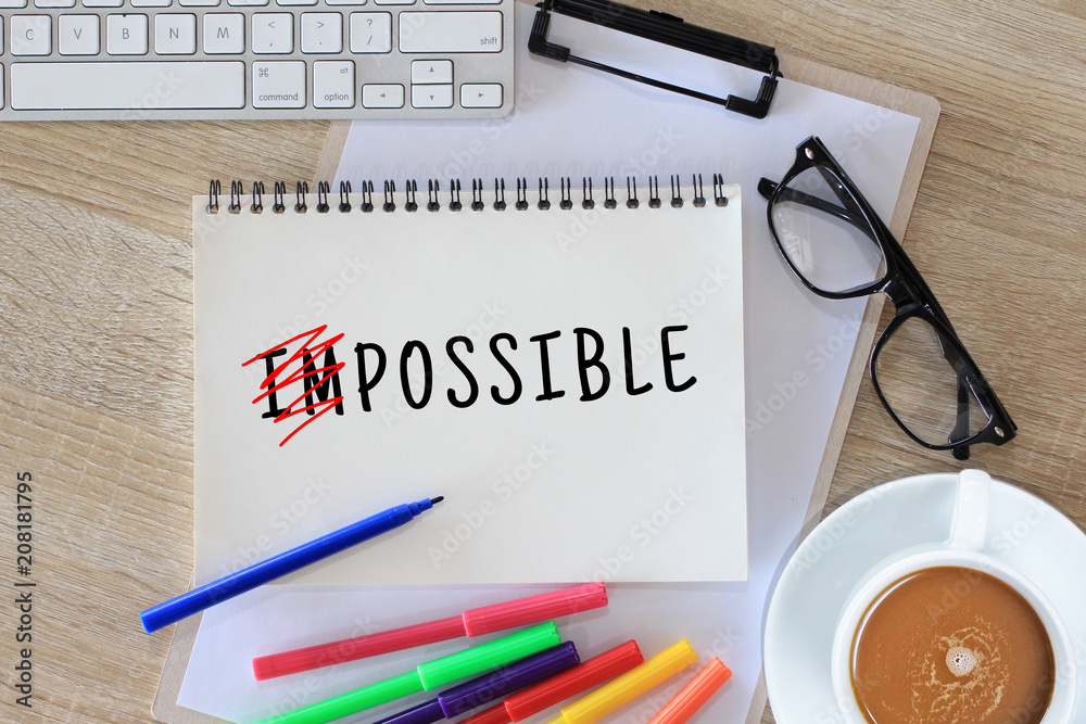 Impossible word concept writing on notebook Impossible word concept writing on notebook