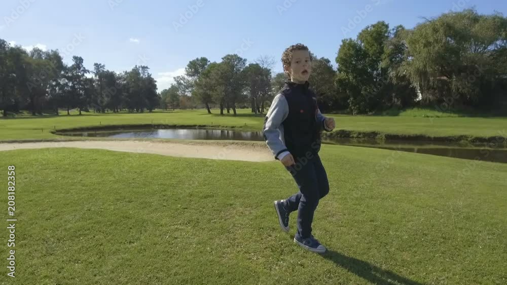 Young little Boy Running - Dancing outdoors park. Slow Motion Young little Boy Running - Dancing outdoors park. Slow Motion