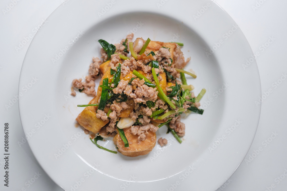 tofu stir fry with pork on white dish tofu stir fry with pork on white dish
