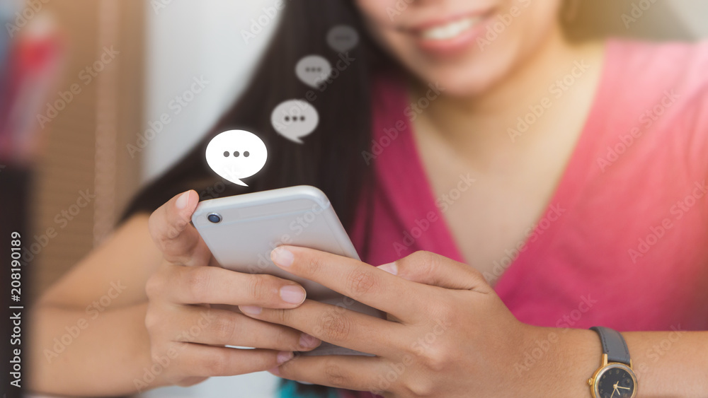 Woman using smartphone with Live Chat Chatting on white table in office space.Concept of business people use technology. Woman using smartphone with Live Chat Chatting on white table in office space.Concept of business people use technology.