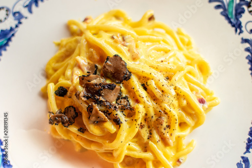 Spaghetti with olive oil and black truffle slices in an Italian restaurant