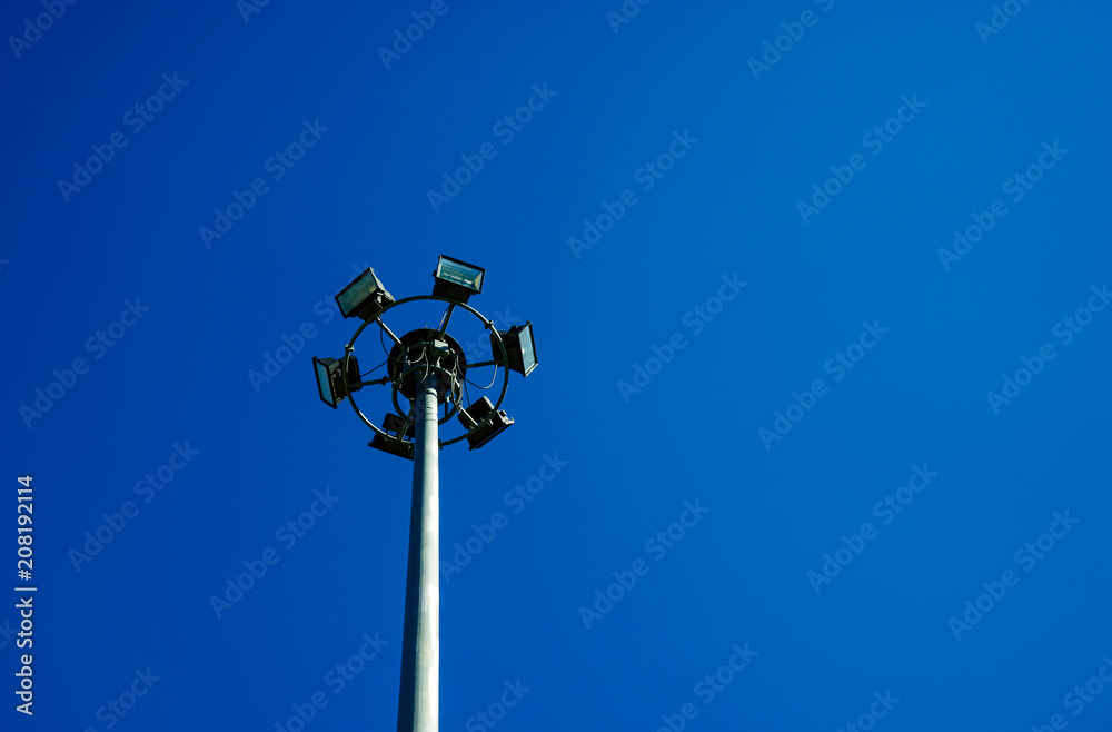 Round steel pole installed spotlights, steel pole with blue sky background.